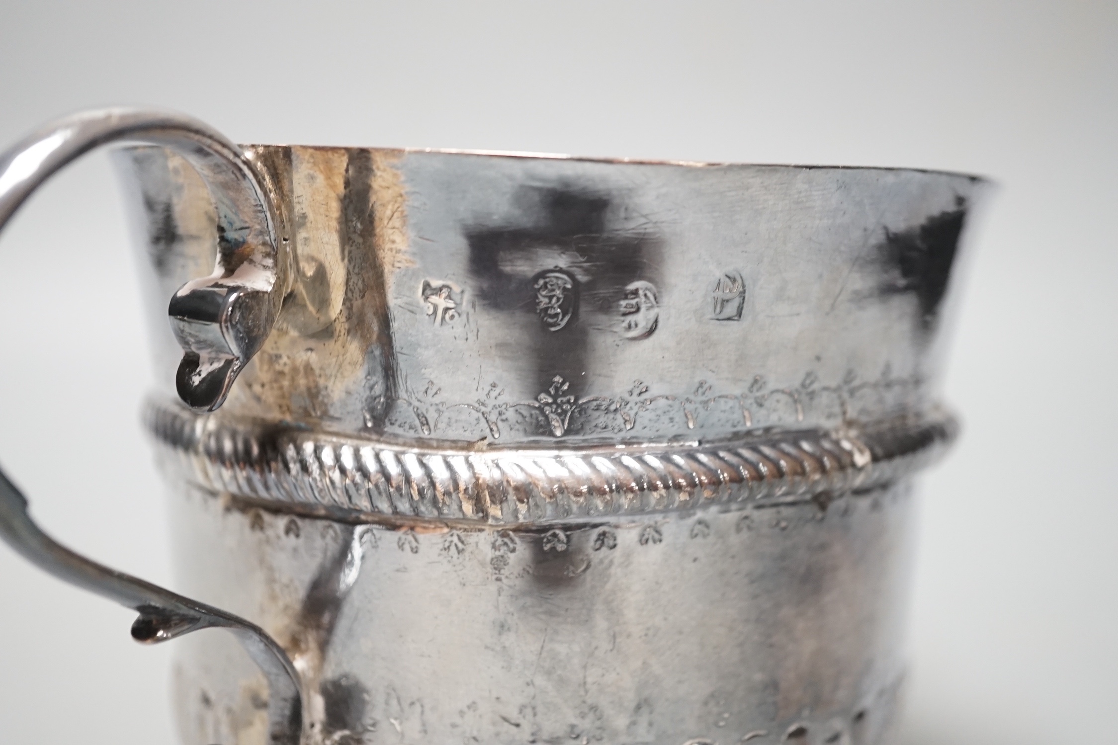 A George I embossed silver porringer, by Thomas Fort, London, 1714, height 91mm, 198 grams, (repairs).